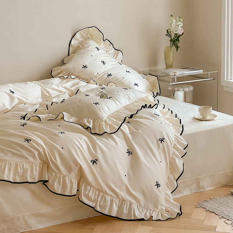Exclusive bedding set in romantic style with ruffle, subtle bow embroidery, and breathable cotton satin