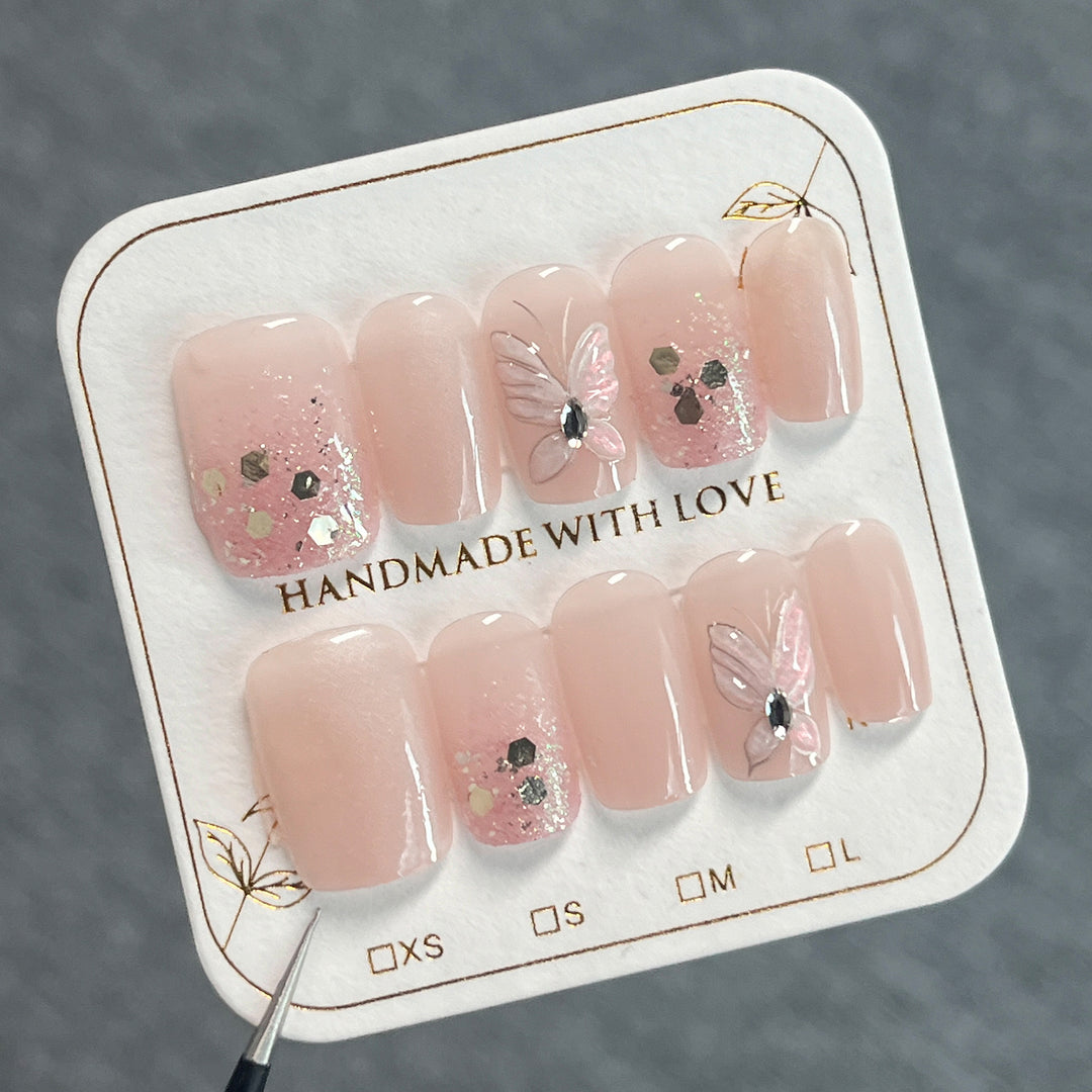Artful nail art with butterfly designs and glitter accents Kalsten