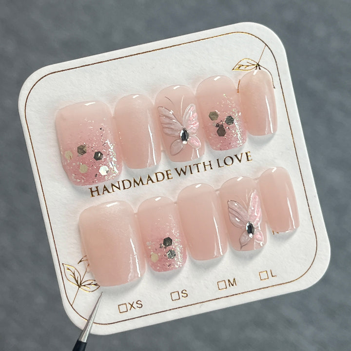 Artful nail art with butterfly designs and glitter accents Kalsten