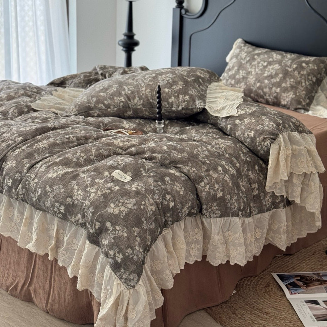 Floral quilted comfort bedspread with lace trim and decorative ruffle