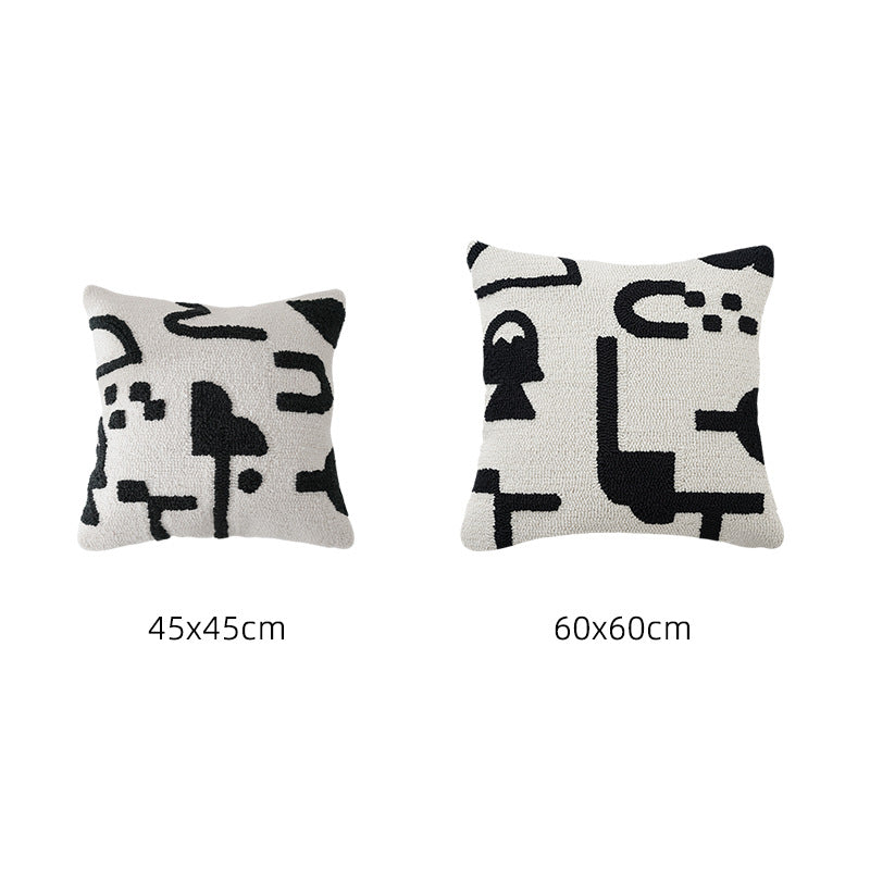 Hand-tufted decorative cushion with abstract graphic design and textured cotton surface