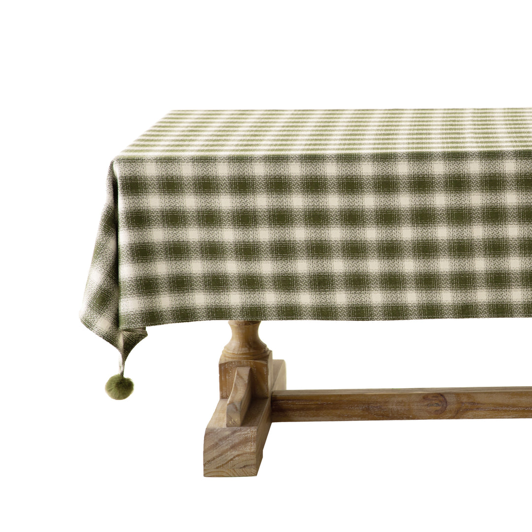 Rectangular checked tablecloth made of cotton blend with pom-pom corners
