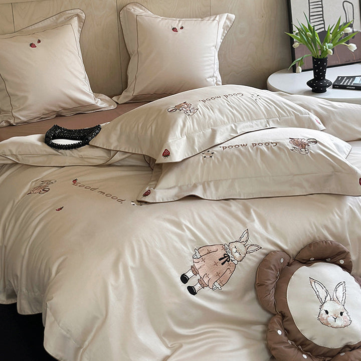 Fine cotton satin bedding set with elaborate bunny embroidery and piped edge