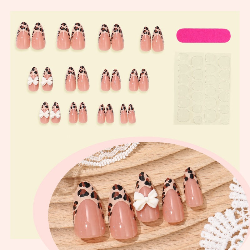 Artificial nail set with elegant leopard design and playful bow accents Kalsten