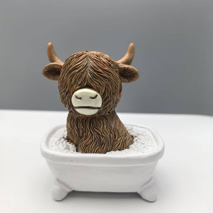 Funny decorative figure of a Highland cow in a bathtub Kalsten