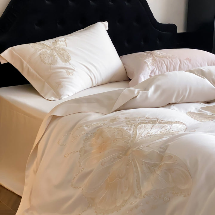 Luxurious satin bedding set with embroidered butterfly motifs and silky glossy finish