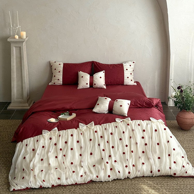 Romantic bed linen set with tulle overlay, pom pom appliqués, and decorative bows