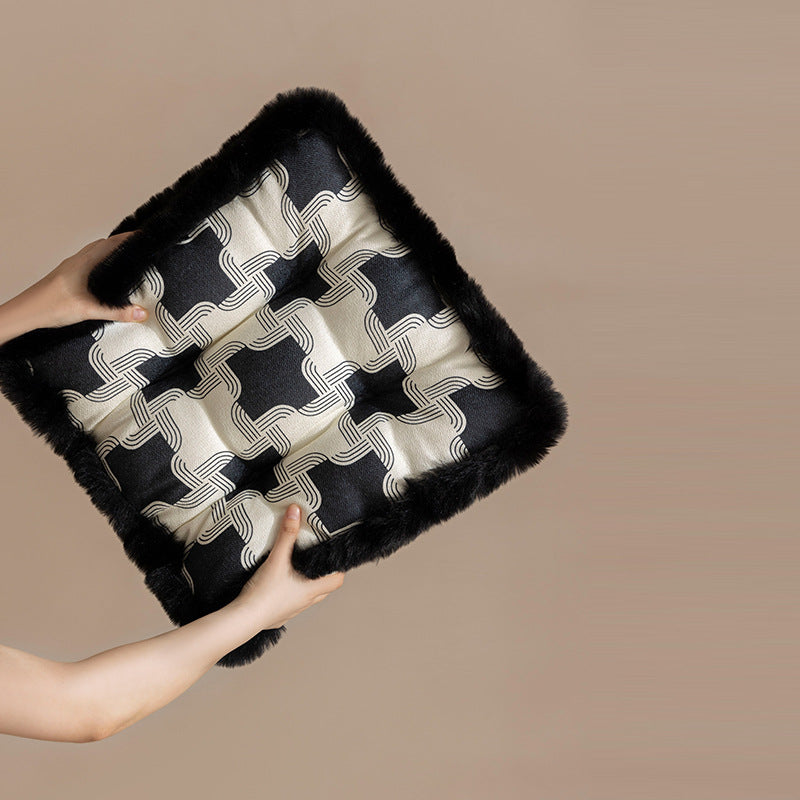 Padded seat cushion with fastening straps and faux fur edge
