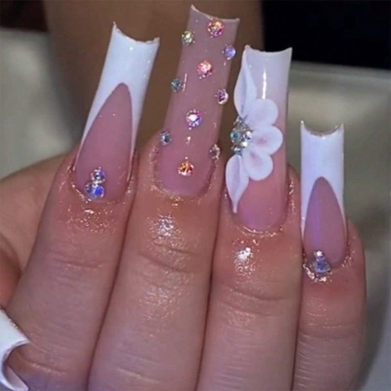 Artful stiletto nails with floral accents and rhinestone details Kalsten