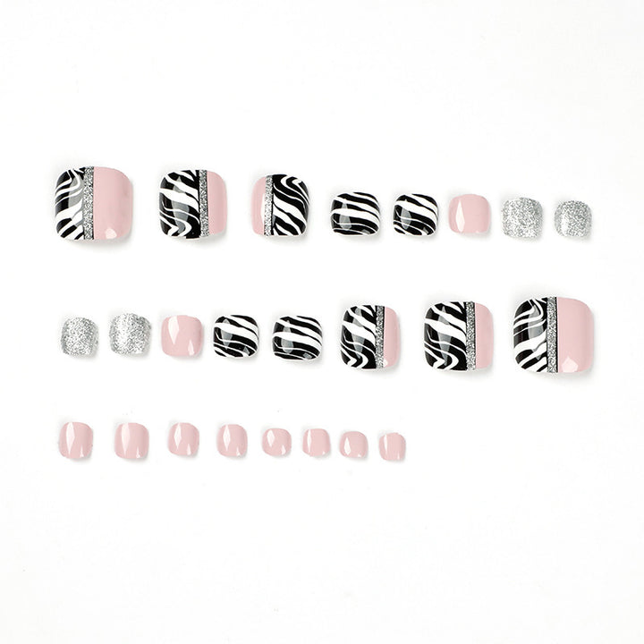 Artistic toenail art with zebra pattern and glitter accents Kalsten