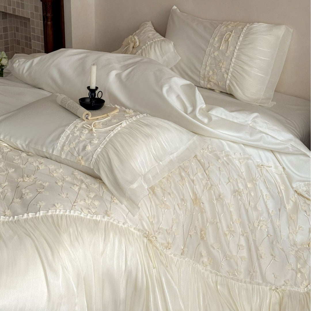 Embroidered bedding set with ruffles and three-dimensional flower appliqués
