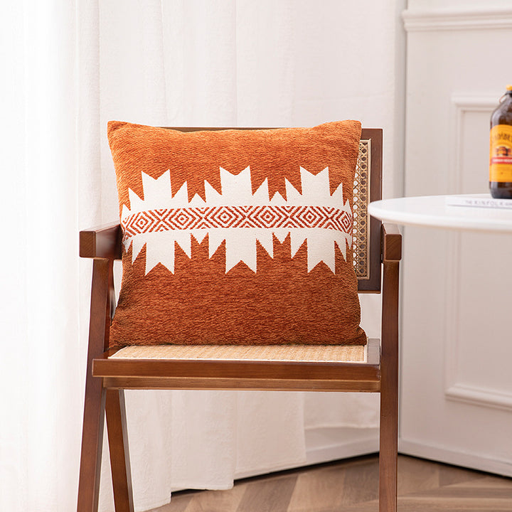 Woven cushion cover with graphic ethnic pattern and contrasting borders