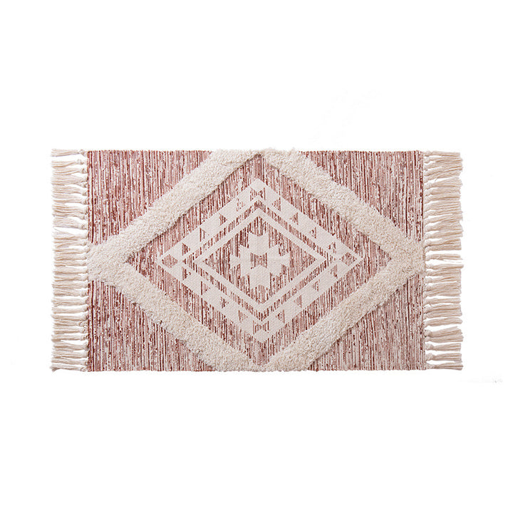 Hand-tufted cotton bath mat with botanical pattern and decorative fringes