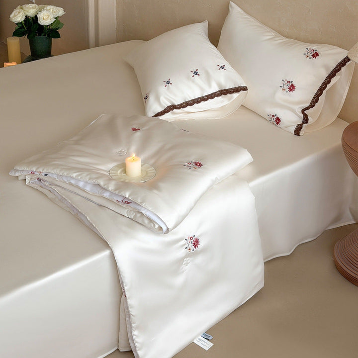 Elegant satin bedding set with fine floral embroidery and lace trim