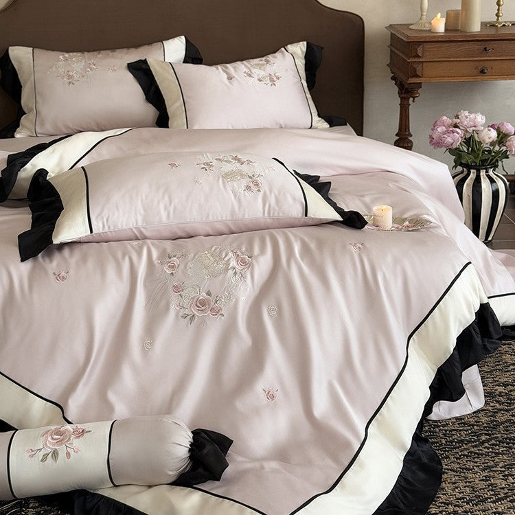 Elegant satin bedding set with floral embroidery relief look, ruffle and contrasting piping seam