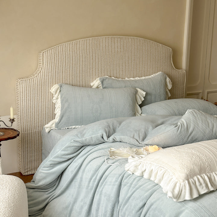 Quilted bedding set with ruffle and medallion relief