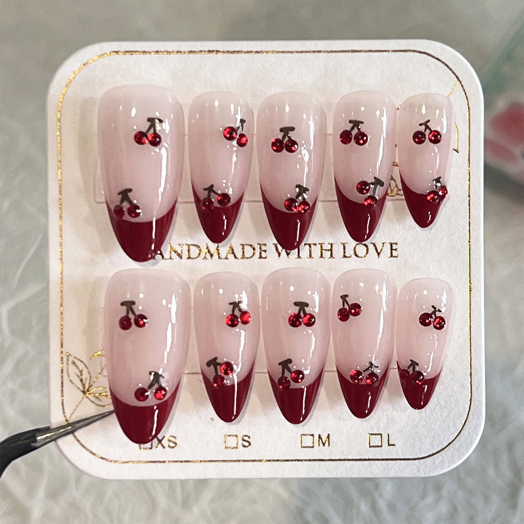 Artful stiletto nails with cherry motifs and glitter accents Kalsten