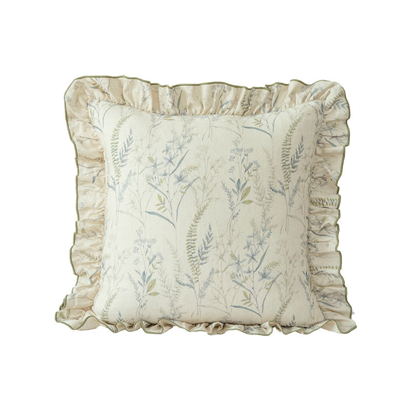 Decorative pillow with ruffles and floral linen cover