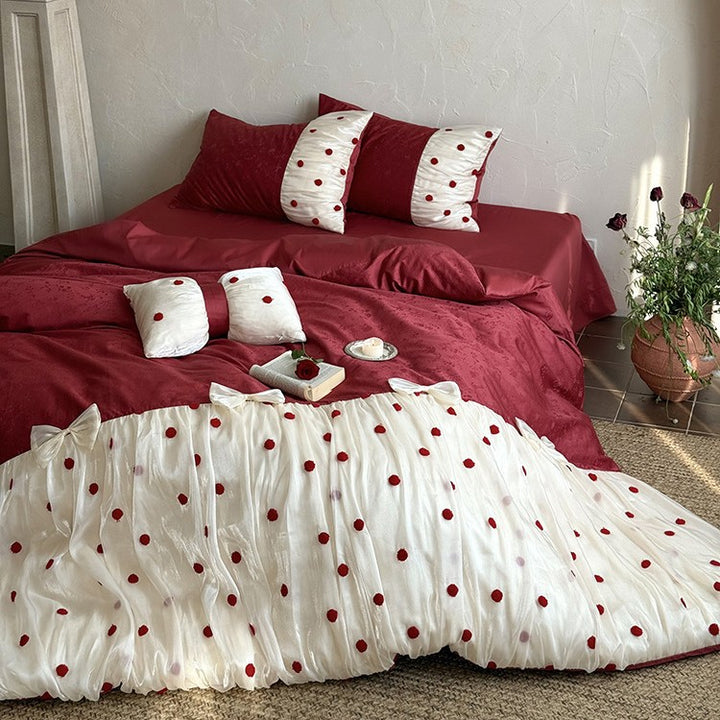 Romantic bed linen set with tulle overlay, pom pom appliqués, and decorative bows