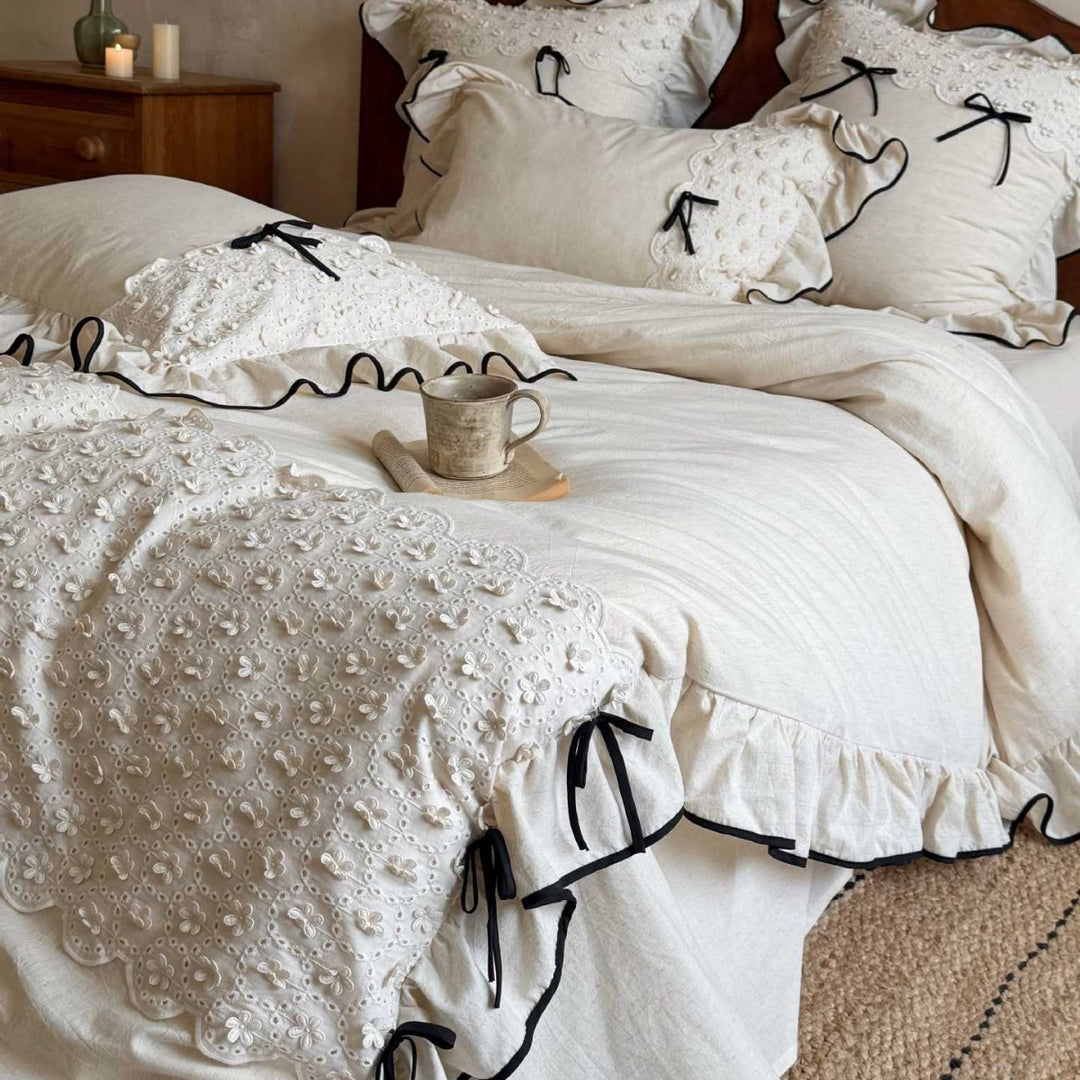 Romantic cotton-linen bed linen set with broderie anglaise, frills, and contrast piping