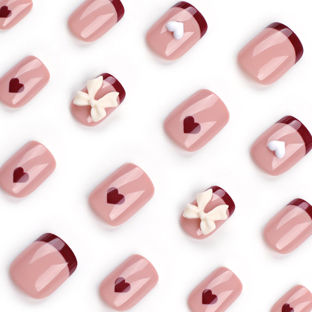 Artful nail art with heart and bow motifs Kalsten