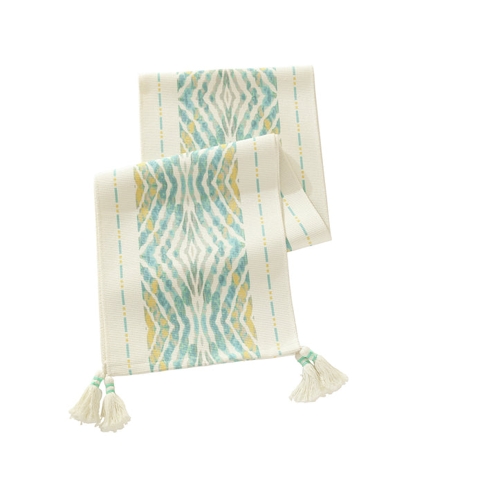 Web table runner made of cotton blend with woven diamond design and tassels