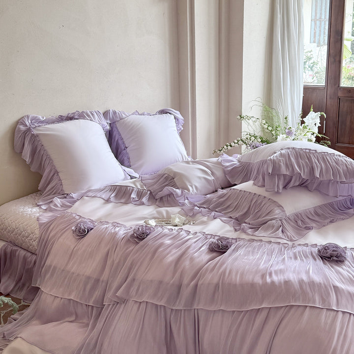 Romantic satin bedding set with layered ruffles and rose appliqués