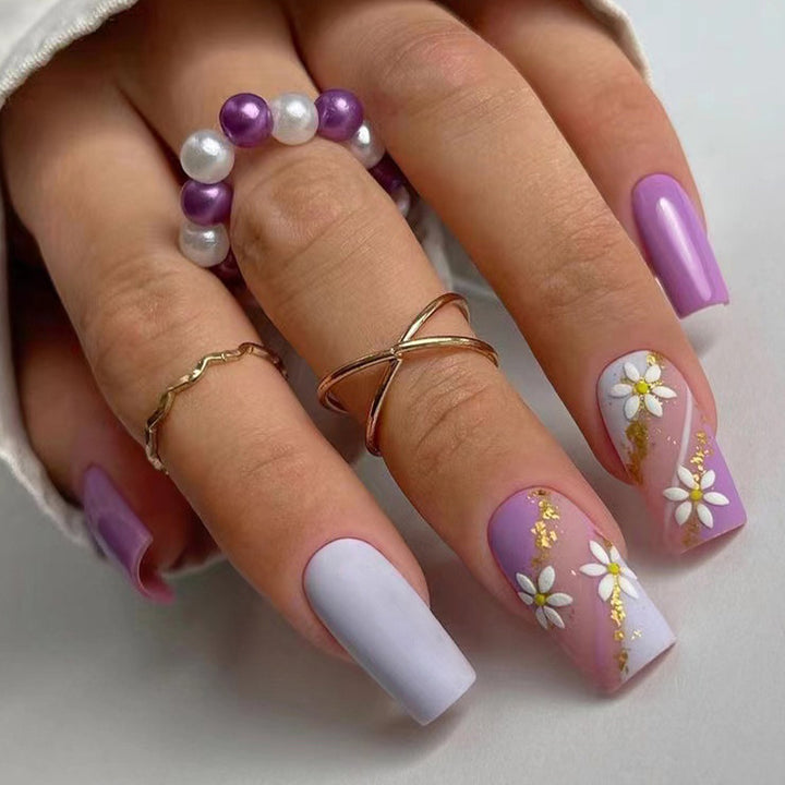 Artistic nail designs with floral motifs and glitter accents Kalsten