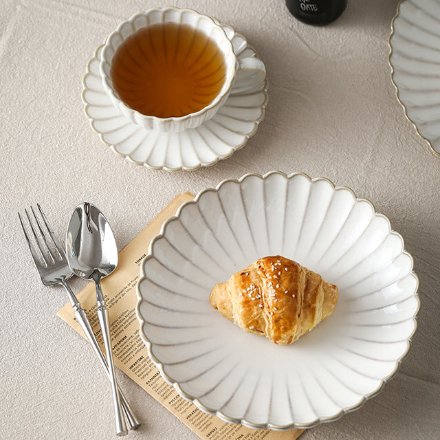 Fine porcelain tea cup set with ribbed shell edge and sculptural handle