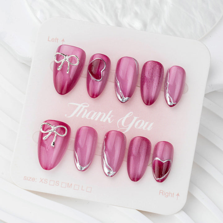Acrylic nail set with elegant heart and bow decorations Kalsten
