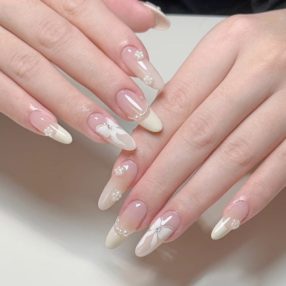 Artistic Press-On Nail Design with Floral and Glitter Accents Kalsten