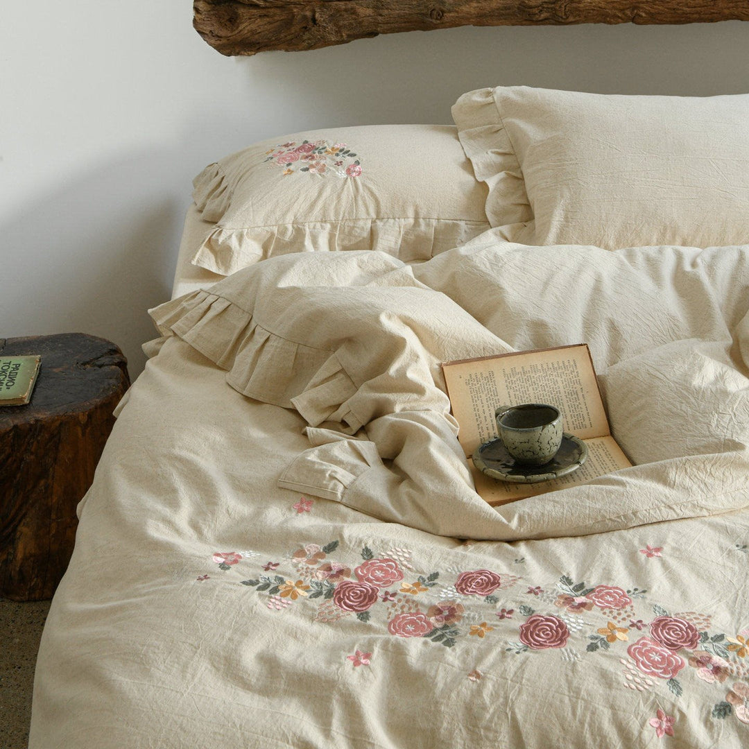 Embroidered linen-look bedding set with ruffle and floral embroidery detail