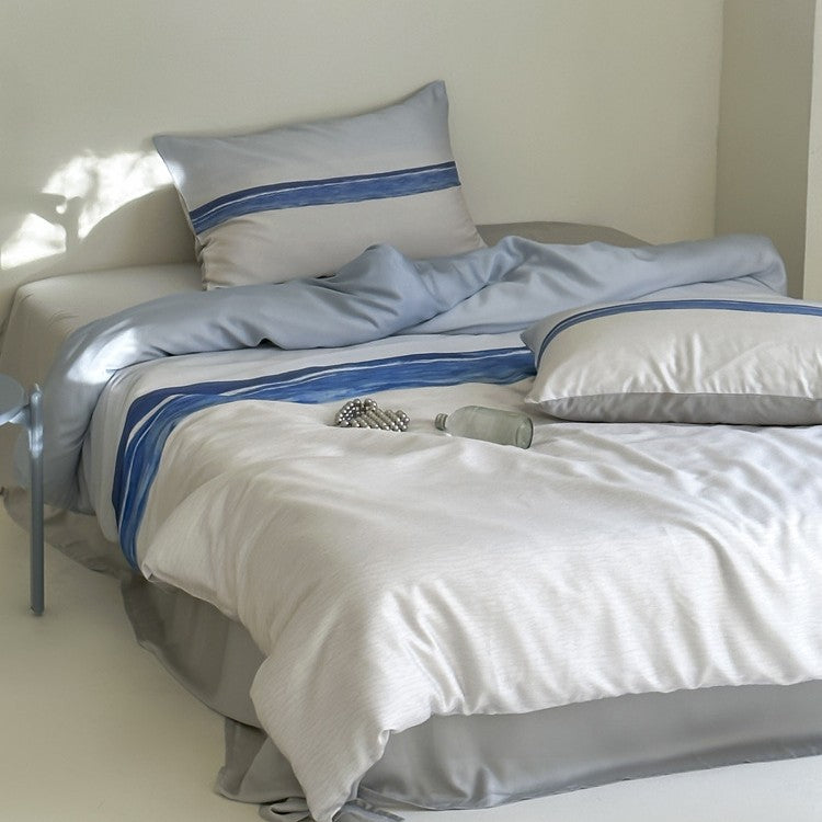 Modern striped bedding set made of cotton satin with hand-drawn stripes and contrasting piping