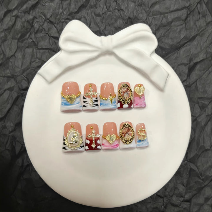 Artistic Press-On Nail Set with Gold Accents and Unique Designs
