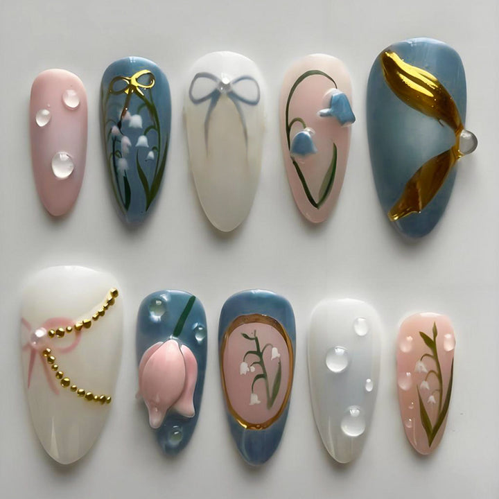 Acrylic nail set with floral design and elegant gold embellishments Kalsten