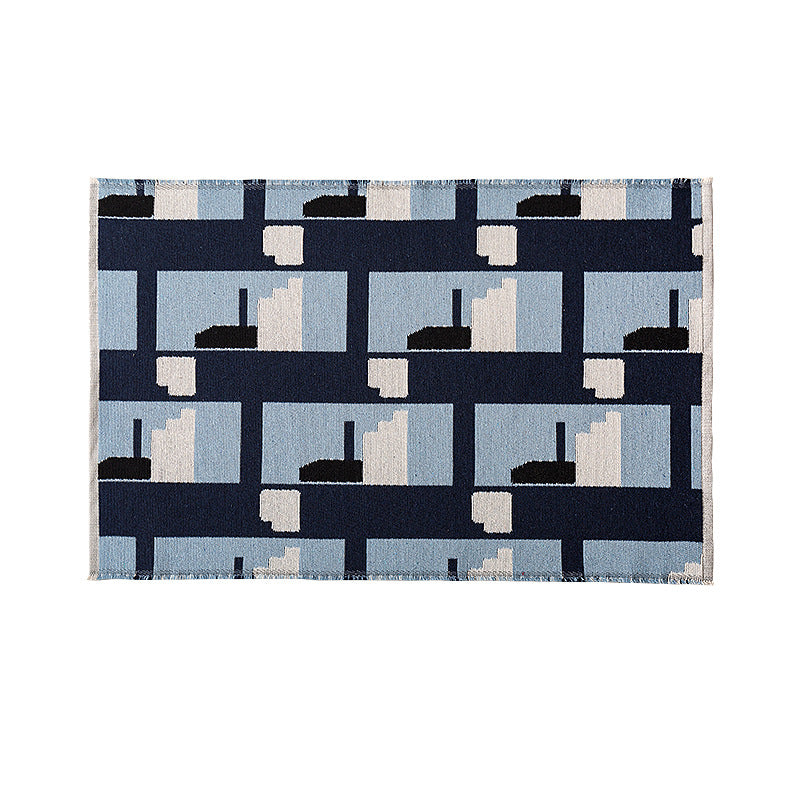 Flat-woven living room rug in a graphic tile pattern