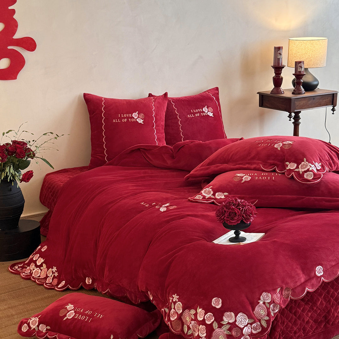 Soft-touch bedding set with floral rose embroidery, wavy hem, and reversible pillow.