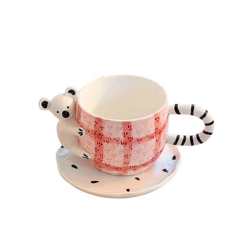 Playful ceramic cup set with koala relief handle and matching saucer