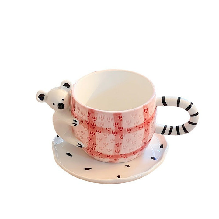 Playful ceramic cup set with koala relief handle and matching saucer