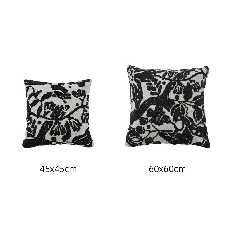 Hand-tufted decorative cushion with abstract graphic design and textured cotton surface