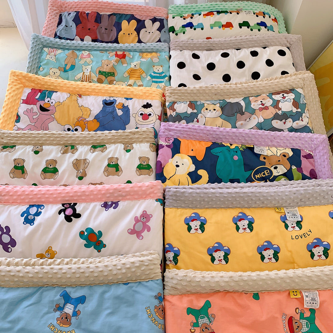 Children's quilt with colorful dinosaur print and soft minky border