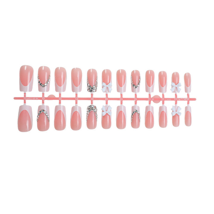 Acrylic nail set with glitter accents and decorative bows Kalsten