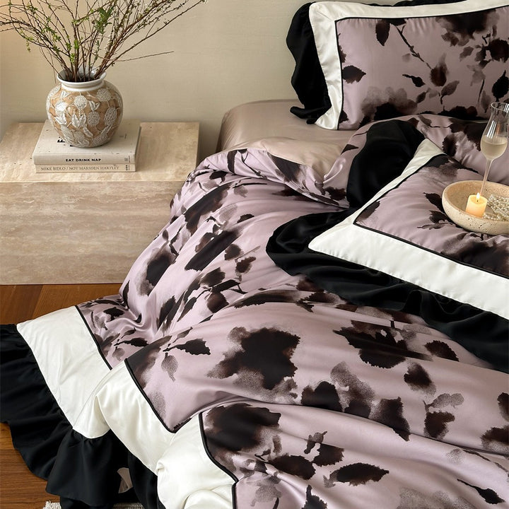 Satin bedding set with watercolored floral print, contrasting piping and flowing ruffles