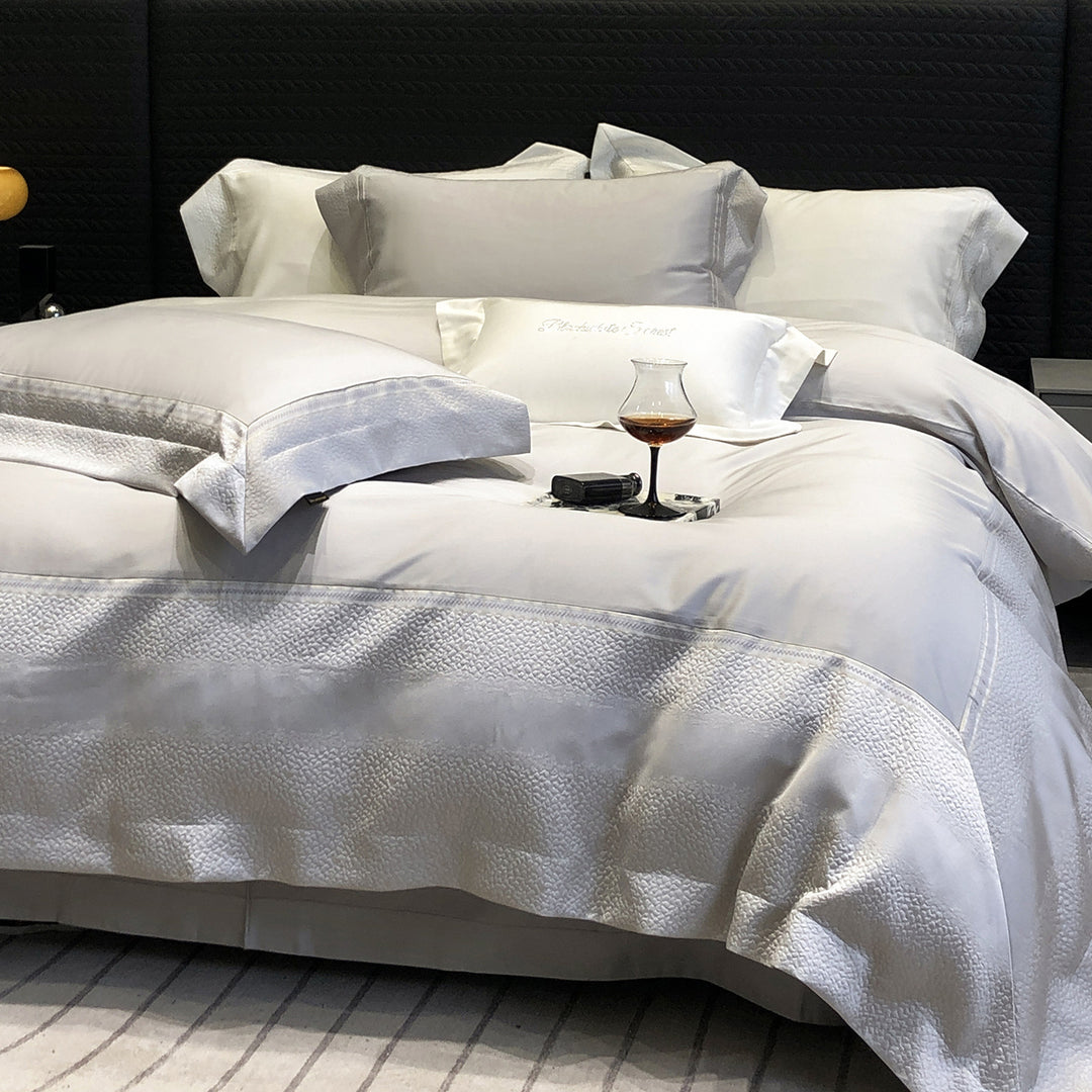 Premium cotton satin bedding set with structured matelassé border and hotel closure