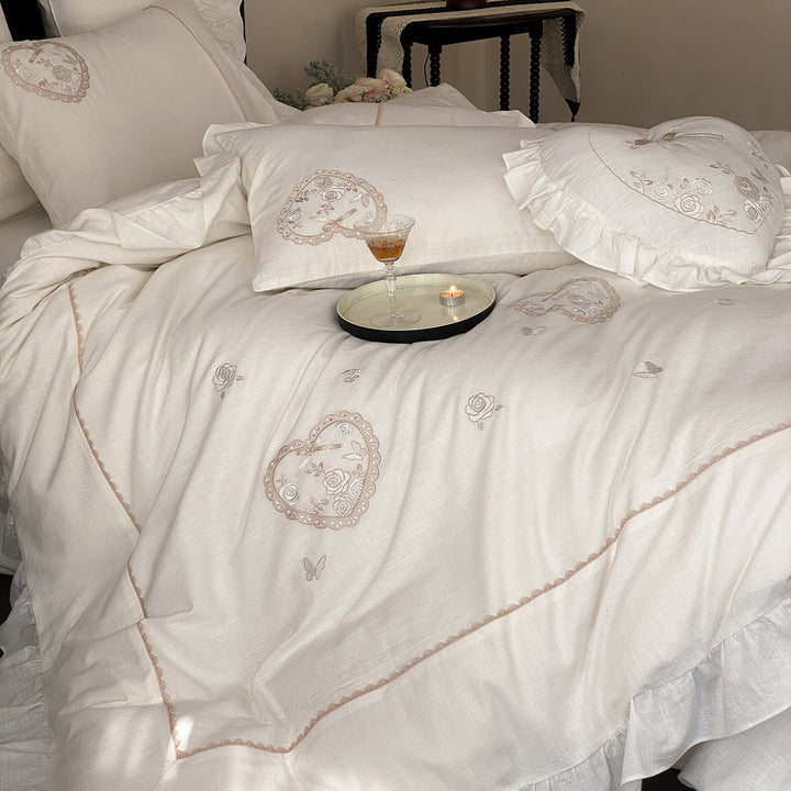 Romantic bedding set with ruffles, heart embroidery, and linen look