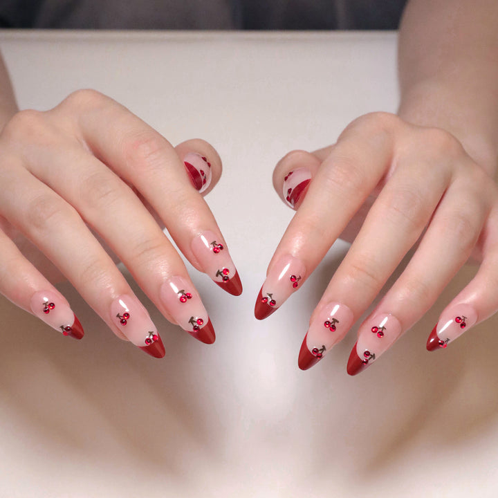 Artful stiletto nails with cherry motifs and glitter accents Kalsten