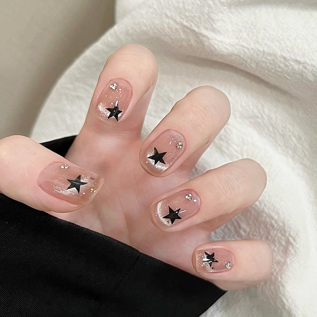 Artistic acrylic nails with glamorous star motifs Kalsten