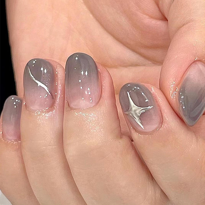 Artificial nail art with elegant ombre design and charming accents Kalsten