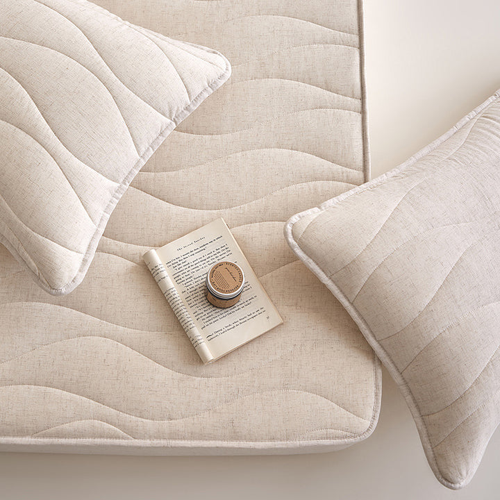 Quilted mattress topper with all-around fitted edge and breathable padding