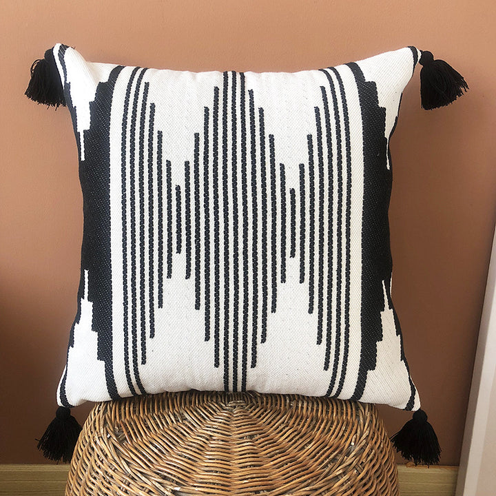 Rectangular woven cushion cover in ethnic jacquard with four tassels and concealed zipper